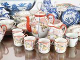 many different types of teapots and cups on the table