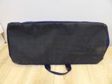 a black bag with a blue handle sitting on a wooden floor