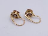 pair of gold tone earrings with brown and white glass beads