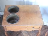 a small wooden table with two bowls on top of it