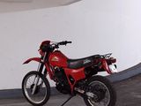 a red motorcycle that is parked in a garage