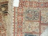 several rugs on the floor with a price tag on them
