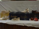 several pairs of women ' s shoes are lined up on a table