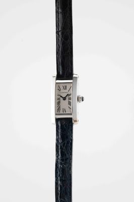 a close up of a watch on a black strap with a white background