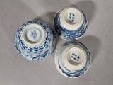 three blue and white vases sitting on a table