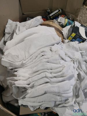 a cardboard box filled with clothes and other items