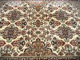 a close up of a large oriental rug on a wooden floor