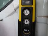 a yellow and black device on the side of a car