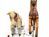 two old fashioned wooden toys that are sitting on a white surface