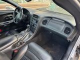 the interior of a car with black leather seats and steering controls