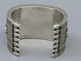 sterling silver cuff bracelet with three rows of leaves on the sides