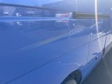 a blue van that is parked in a parking lot