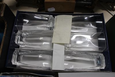 six empty wine glasses in a box on a table