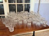 a lot of empty glasses on a table in front of a window