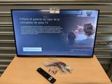 une télévision posée sur une table, avec une télécommande