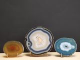 three pieces of agite are sitting on a table with a black background