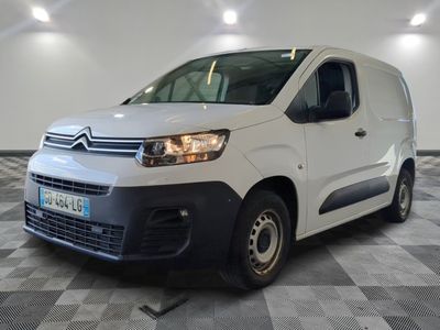 the white van is parked in a large room with a checkered floor