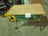 a table with a sign on it in a warehouse