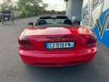 a red sports car parked in front of a building