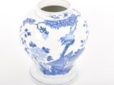 a blue and white vase sitting on a white surface