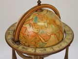 a small globe on a stand with a wooden base