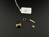 a close up of a gold ring with a bullet on a black surface
