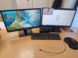 deux écrans d'ordinateur et un clavier sur un bureau