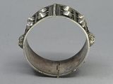 an image of a silver ring on a table with a gray background