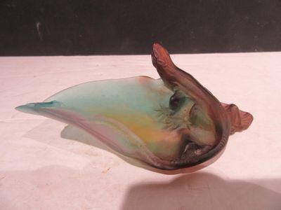 a small glass bird that is sitting on a table