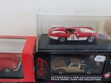 a red and white car and a red and white car in a display case