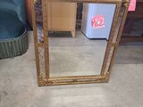 a mirror that is sitting on the floor next to a chair