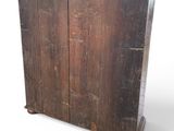 an old wooden cabinet with two doors on it
