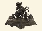 a statue of a man riding a horse on a base