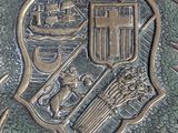 an image of a metal plaque with a coat of arms and a crown on it