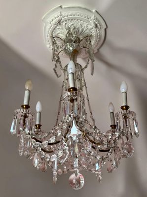 a crystal chandelier hanging from the ceiling in a room