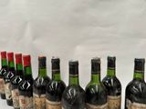 several bottles of wine are lined up in a row on a table