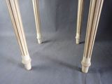 two tables that have been painted white and are sitting on a gray surface