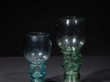 two glass goblets sitting on a table