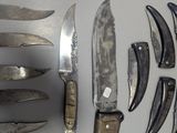 many different types of knives and knives on the table