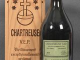 a bottle of wine in front of a wooden box