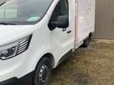 a picture of a white van parked in front of a building
