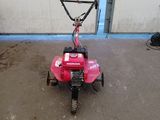 an image of a pink lawn mower parked in a garage