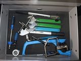 a metal box with tools in it on the floor