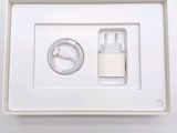 a white box with a charger and a cable in it