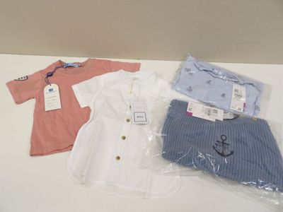 three baby clothes on a table next to each other