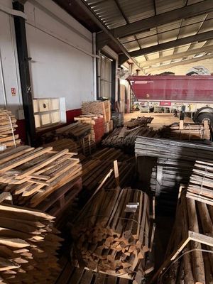 many pieces of wood stacked up in a warehouse