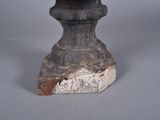 a statue of a man with a hat on top of a rock