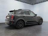 the mini countryman is parked in a garage with a roof rack