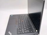 a laptop computer sitting on a table with a keyboard