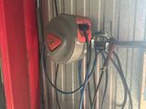 an image of a garage with a red door and some tools